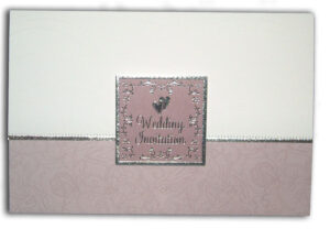 light pink folded floral wedding invitation with silver border and love hearts