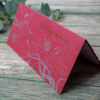 red single fold wedding invitation with gold floral design on the front