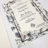 white wedding invitation with black illustrated roses and wildlife