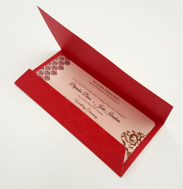 Pakistani wedding invitation card in bright red
