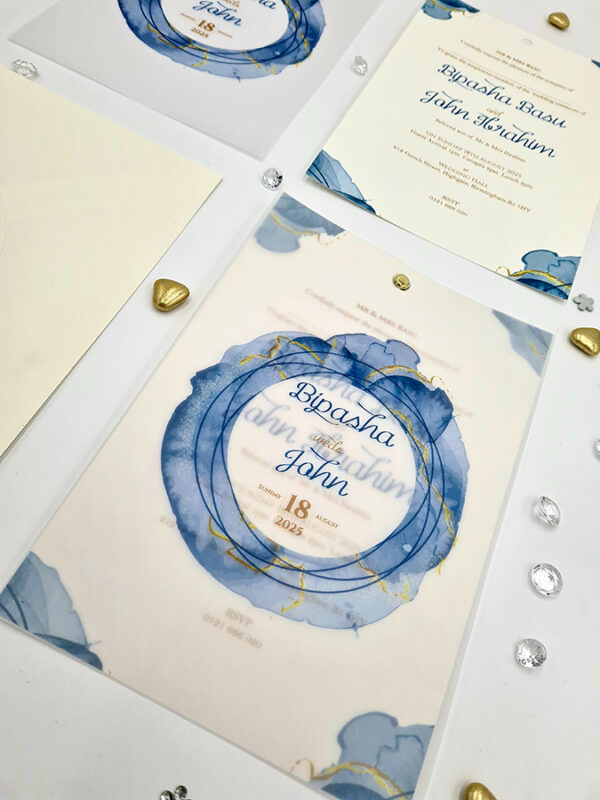 vellum wrapped invitations with gold brad pin